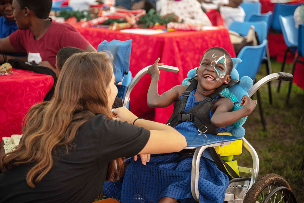 A GoldStar volunteer sharing a moment with a child at the Ruparelia Foundation children's Christmas party.